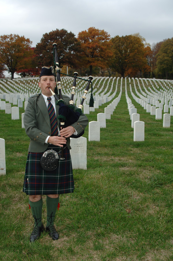 Bagpiper Paul Cora piping memorial music on his bagpipes at a Veterans Cemetery